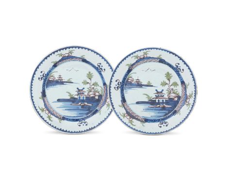 A large pair of Lambeth delftware plates, circa 1770Painted in blue, green and manganese with a chinoiserie landscape depicti