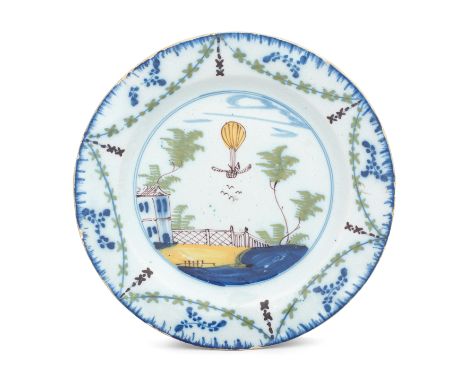 A Lambeth (Thomas Morgan and Abigail Griffith) delftware ballooning plate, circa 1785Painted in blue, green, yellow and manga