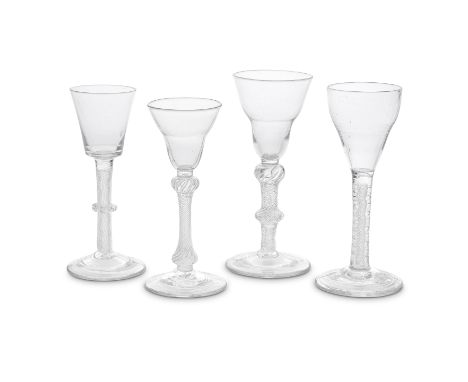 Four airtwist wine glasses, circa 1750Three with multi-spiral airtwist stems and conical feet, comprising one with a bucket b
