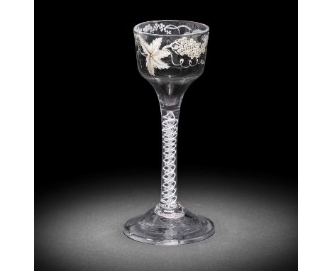 A Beilby enamelled opaque twist wine glass, circa 1765The ogee bowl painted with fruiting vine in opaque white, faint traces 