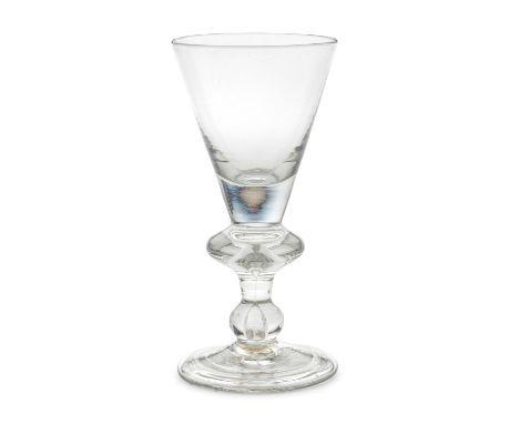 A good heavy baluster goblet, circa 1710The conical bowl solid at the base, on a stem with a wide angular knop containing a t