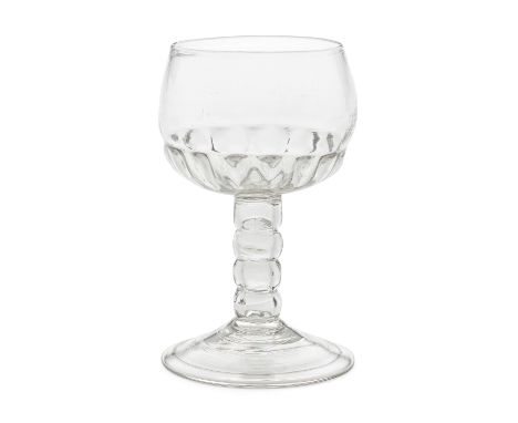 A very rare bobbin-knopped mead or champagne glass, early 18th centuryThe distinctive cup shaped bowl moulded with a ring of 
