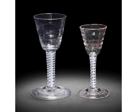 Two good 'Lynn' opaque twist wine glasses, circa 1765One with a generous round funnel bowl moulded with two concentric rings,