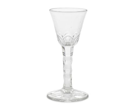 An unusual facet stem wine glass, circa 1770The generous round funnel bowl cut with thumbnail facets, the hexagonal stem cut 