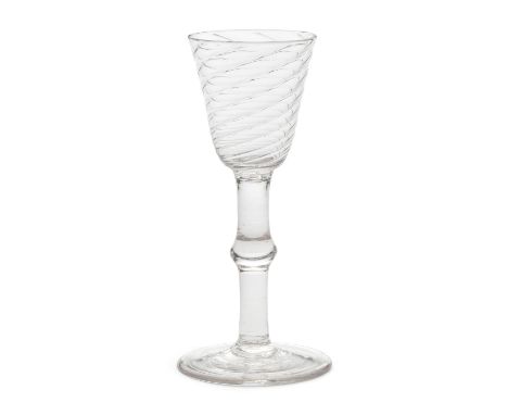 A very rare baluster wine glass, circa 1740-50The generous round funnel bowl finely wrythen-moulded, the tall plain stem with