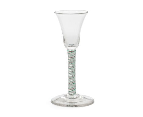 A red and green colour twist wine glass, circa 1765The small bell bowl on a stem containing a multi-ply corkscrew edged on bo