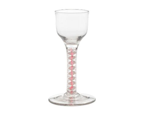 A red colour twist wine glass, circa 1765The ogee bowl on a stem containing a central translucent ruby-red corkscrew edged by
