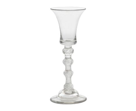 A very rare four-knopped airtwist wine glass, circa 1750The waisted bucket bowl on a multi-spiral airtwist stem with two uppe