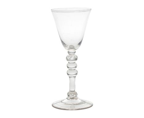 An attractive light baluster wine glass, circa 1750The generous round funnel bowl on a slender multi-knopped stem with a smal