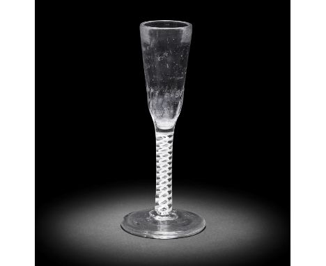 A remarkable deceptive opaque twist ratafia glass, circa 1770,The tall thick-walled ogee bowl moulded with fine basal flutes,