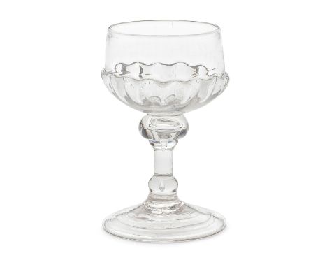 A baluster mead or champagne glass, early 18th centuryOf attractive small size, the distinctive cup shaped bowl moulded with 