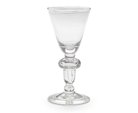 A fine acorn-knopped heavy baluster goblet, circa 1710-15The generous round funnel bowl with a solid base containing a tear, 