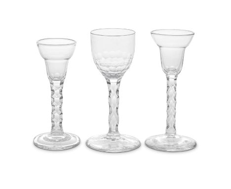 Three good facet stem wine glasses, circa 1775-85One with a generous ovoid bowl cut with scale-like facets to the base, the s
