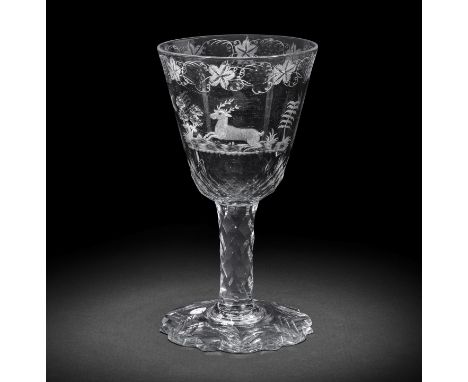 An engraved facet stem goblet, circa 1780-90The generous round funnel bowl decorated to both sides with a landscape vignette 