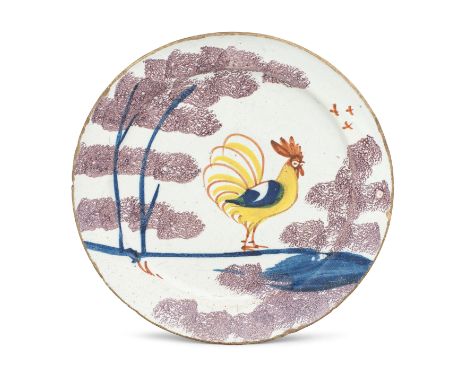 A Bristol delftware 'Farmyard' plate, circa 1720-30Of 'pancake' profile without a footrim, painted in red, yellow and dark bl