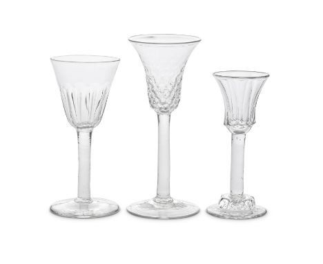 Three attractive plain stem wine glasses, circa 1750One with a bell bowl with graduated honeycomb moulding to the lower part,