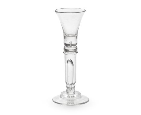 A rare cylinder-knopped baluster wine or cordial glass, circa 1720The trumpet bowl with a solid base containing a small tear,