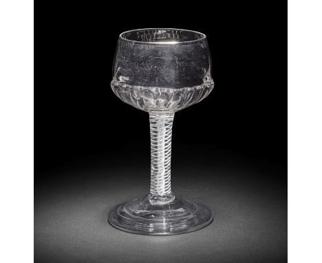 A rare opaque twist mead or champagne glass, circa 1760-70The distinctive cup shaped bowl moulded with a ring of twenty evenl