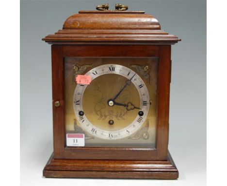 An Elliott walnut cased bracket clock in the Georgian style having striking and chiming movement
