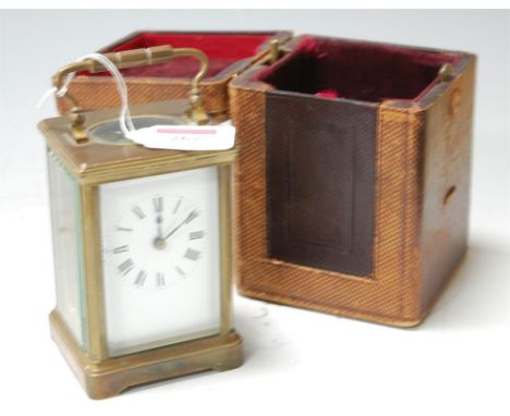A circa 1900 lacquered brass carriage clock having visible platform escapement and with outer leather carry case