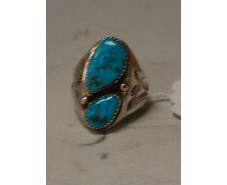 An Arts & Crafts white metal and turquoise set ring 