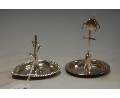 An Edwardian silver heart shaped ring tree together with one other in the form of a lamppost (2)