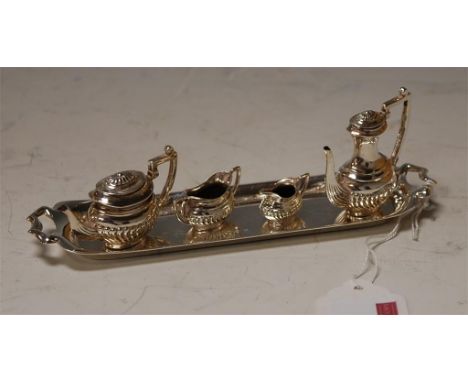 A dolls four piece silver miniature tea and coffee service with twin handled cabaret tray, all in the  Regency style