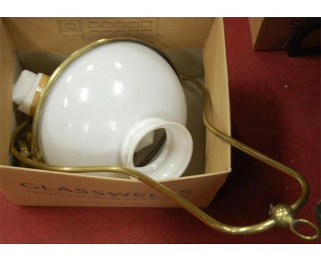 A circa 1900 brass hanging oil lamp with opalescent glass shade