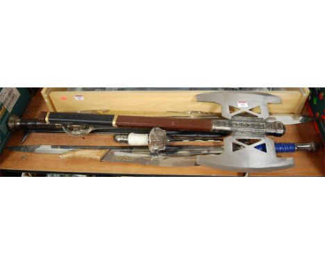 A collection of various Lord of the Rings and mythical show cased display weapons to include Uruk-Hai swords and Gimli's axe 