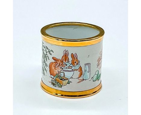 Gold rimmed napkin ring depicts a scene from the Tales of Peter Rabbit. This pieces features a quote from the popular story a