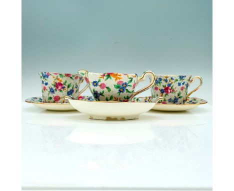 A Royal Winton china set that has a chintz floral design and a pebble like background consisting of 2 teacups, 2 saucers, a c