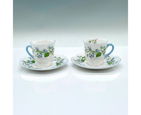 2 espresso cups with matching 2 saucers, adorned with blue flower pattern and light blue trims. Shelley backstamps. Cup: 3"L 