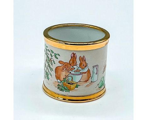 Gold rimmed napkin ring depicts a scene from The Tales of Peter Rabbit. This pieces features a quote from the popular storybo