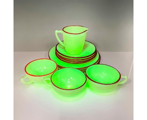 This adorable depression era uranium glass 12-piece set is a lovely cream color base with red trim and has an embossed laurel