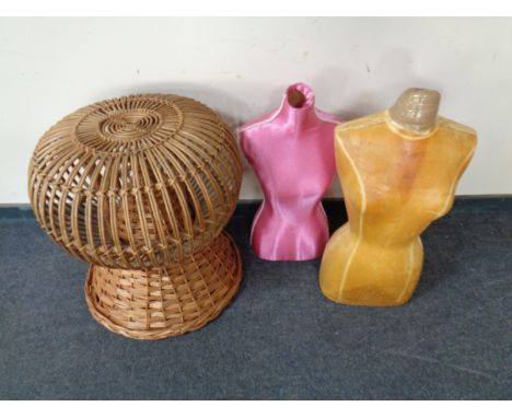 Two mannequin torsos together with a basket on stand 