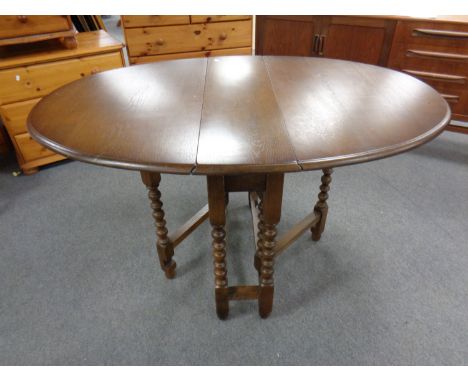 A reproduction oak gate leg table 