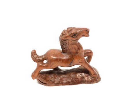 A carved Chinese hardwood netsuke - Cantering foal