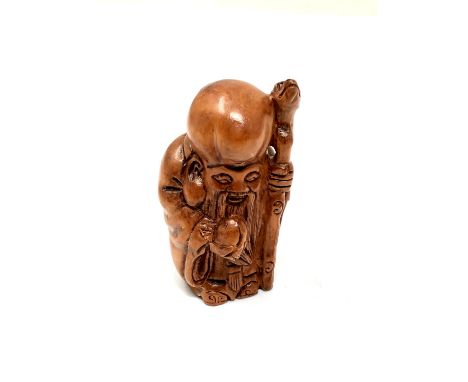 A carved Chinese hardwood netsuke - Village elder with staff