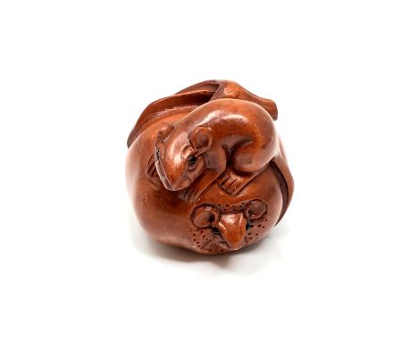 A carved Chinese hardwood netsuke - Two rats eating a large fruit 