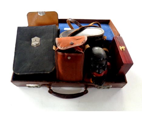 Two leather brief cases containing cast metal money box, leather cased travel set, boxed pen knife, Brownie reflect camera in