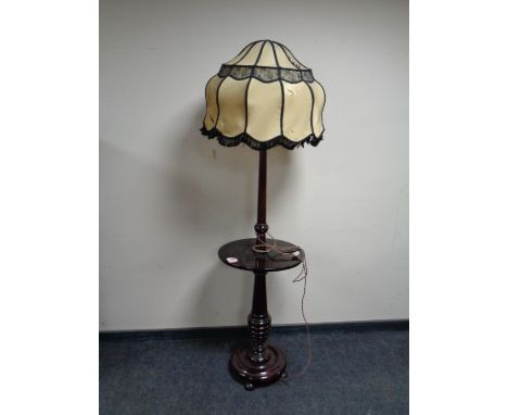 A mahogany standard lamp table with shade 