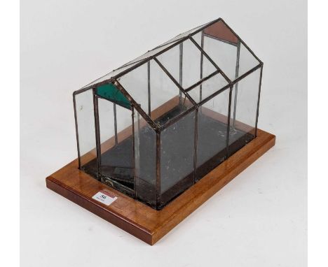 A Victorian style glazed terrarium of architectural form standing on a rectangular walnut plinth, height 20cm