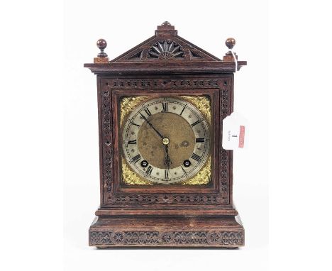 A 19th century oak cased mantel clock having an arched pediment with blind fret carved case, the silvered chapter ring with R