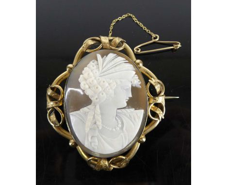 A carved shell cameo portrait brooch, in pierced pinchbeck mount with closed back, circa 1900, full dimensions 6.5 x 5.7cm