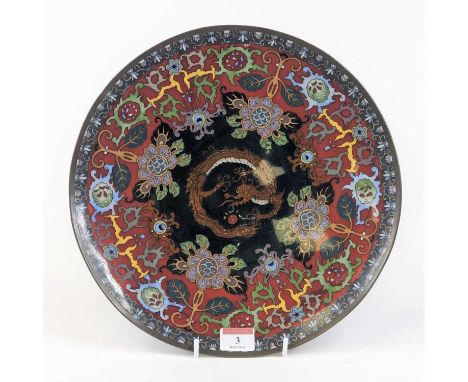 A Chinese cloisonne enamel charger, the centre decorated with a dragon surrounded by chrysanthemums and further red floral de