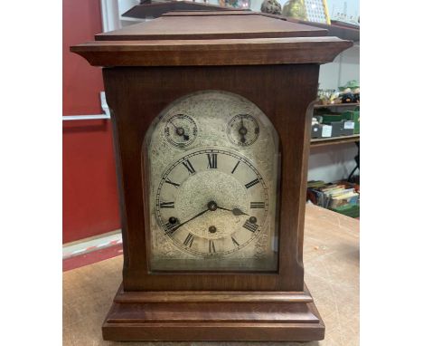 A 19th century mahogany cased mantel clock, the silvered dial with Roman numerals, two subsidiary dials slow/fast and strike/