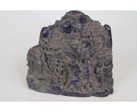 A carved blue resin model of figures before a mountain landscape, height 15cm
