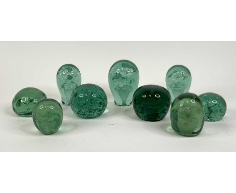 A collection of nine Victorian green glass dump paperweights, largest height 13cmThe larger squat dark green has small chip t