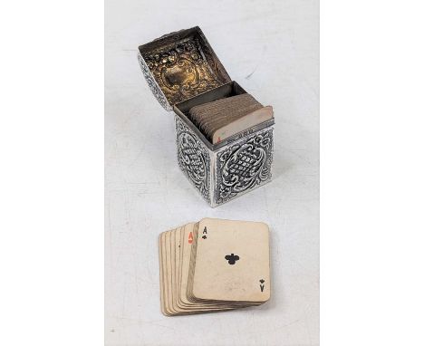 An Edwardian silver miniature playing card case, the domed hinged lid with vacant cartouche, the whole repousse decorated wit