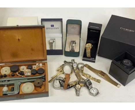 A collection of fashion watches, some in boxes and cased watchmaker's tools
